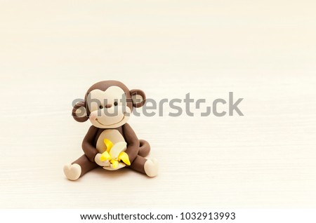 little monkey toy sitting with a banana, marzipan decorations