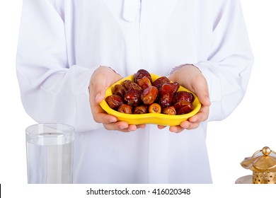 Little Muslim Kid Presenting A Dish Of Dates For Iftar - Breaking Fast In Holy Ramadan  - Showing Generosity Of Ramadan
