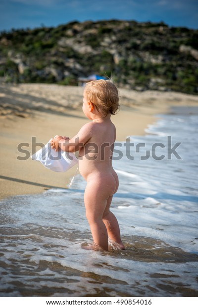  nudist little boys Young boy naked nude or bare playing on a beach by the sea ...