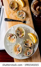 Little Neck Clams. Fresh clams served with garlic, shallots, cocktail sauce, mignonette sauce and fresh lemons and limes. Classic American steakhouse or French bistro appetizer.