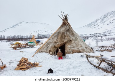 Little Nenets girl near the entrance to the chum, Yamal - Shutterstock ID 2083979212