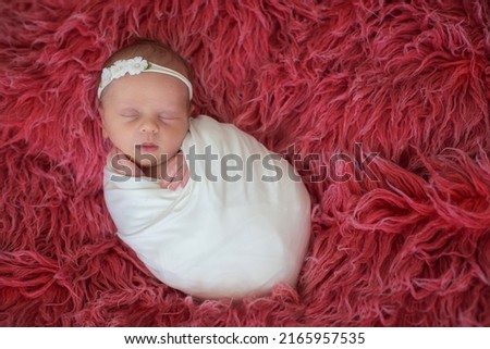 Little newborn baby girl, smiling, infant studio shot