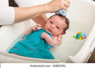 Little Newborn Baby Having A Bath