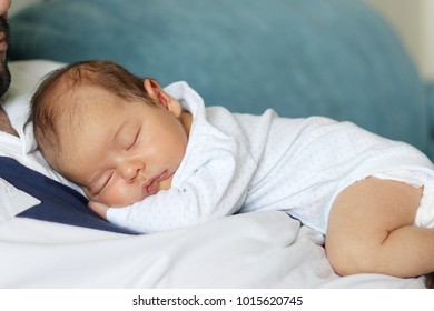 baby sleeping on dads chest