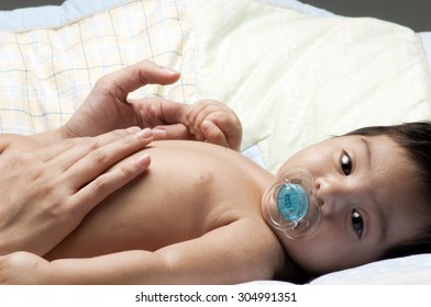 A Little Newborn Latino Baby In Various Poses.