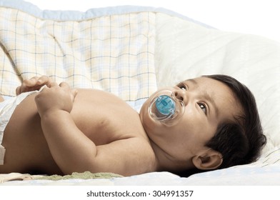 A Little Newborn Latino Baby In Various Poses.