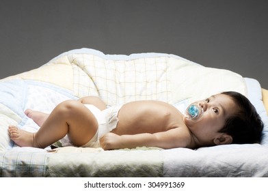 A Little Newborn Latino Baby In Various Poses.