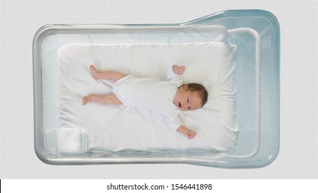 Little newborn moving in a hospital child bed