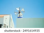 little Old restored small windmill in Aljezur, Portugal, against the blue sky