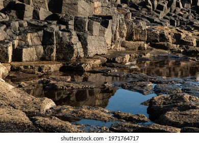 Little Paddle Next To The Ocean. Vulcanic Rock With Pilar Shape Gives Depth To The Seen