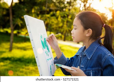 Little Painter At Work In The Park With Palette And Canvas, Butter Fly Drawing With Gild In Park Wint Green Outdoor Backgroung, Kid, Teen And Student Concept.