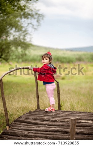 Similar – Image, Stock Photo Little girl climbing to a wooden observation tower in a wetland