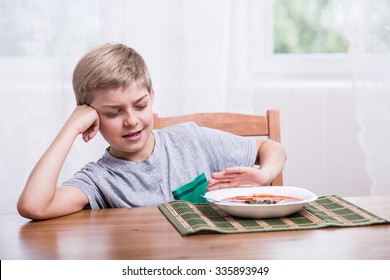 Little Picky Eater Sitting At The Table