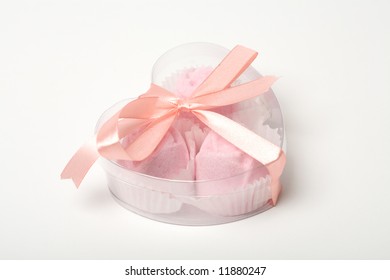 Little pink cakes in a heart shaped box over white background - Shutterstock ID 11880247