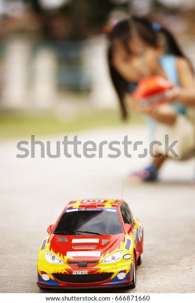 little playing the
remote car at the park