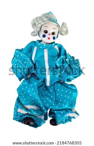 Little porcelain clown in blue dotted overalls, isolated.