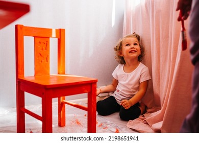 Little Preschool Age Girl Painting Chair In Red Color. Furniture Repair.