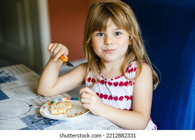 Little Preschool Girl Eating Apple Pie Cake At Home.