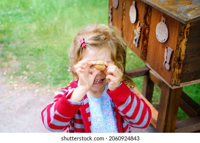 Little Preschool Girl Exploring Life Of Squirrels In Forest. Active Happy Child Learning About Food Of Animals. Children And Environment, Forest Life And Wild Nature.