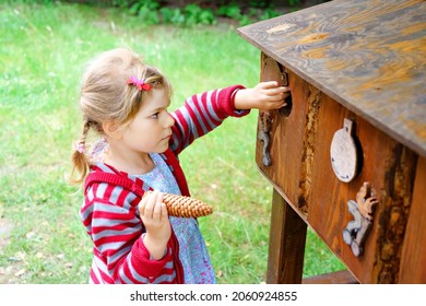 Little Preschool Girl Exploring Life Of Squirrels In Forest. Active Happy Child Learning About Food Of Animals. Children And Environment, Forest Life And Wild Nature.