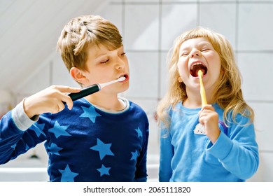 Little preschool girl and preteen school boy brushing teeth. Brother teaching sister brush teeth. Happy siblings. Two children having fun with morning dental routine. Family indoors. - Powered by Shutterstock