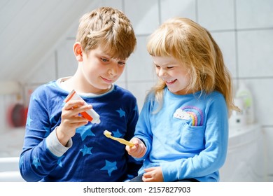 Little preschool girl and preteen school boy brushing teeth. Brother teaching sister brush teeth. Happy siblings. Two children having fun with morning dental routine. Family indoors. - Powered by Shutterstock