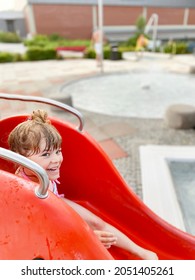 Little Preschool Girl Splashing In An Outdoor Swimming Pool On Warm Summer Day. Happy Healthy Toddler Child Enjoying Sunny Weather In City Public Pool. Kids Activity Outdoors With Water.