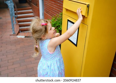 Little Preschool Girl Throwing Letter In A Mailbox. Excited Child Writing Card Or Letter For Grandparents Or Family. Old Fashioned Way Of Communication.