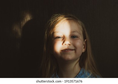 Little Pretty Girl Smiling With Sunny Bunny On Face. Cute Child With Blue Eyes Laughing. Long Blond Hair. Vintage Lens Kids Home Portrait In Daylight. Growing Up Psychology Personal Development.