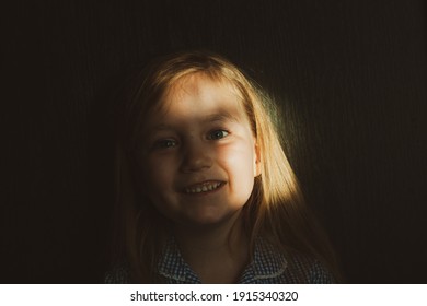 Little Pretty Girl Smiling With Sunny Bunny On Face. Cute Child With Blue Eyes Laughing. Long Blond Hair. Vintage Lens Kids Home Portrait In Daylight. Growing Up Psychology Personal Development.