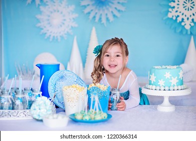 Little Princess Girl On A Styled Frozen Birthday Party With Snowflakes Cakes