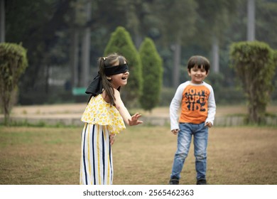 Little princess playing blindfolded game with his friend