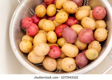 Little Red And Gold Potatoes Getting Washed In Colander.