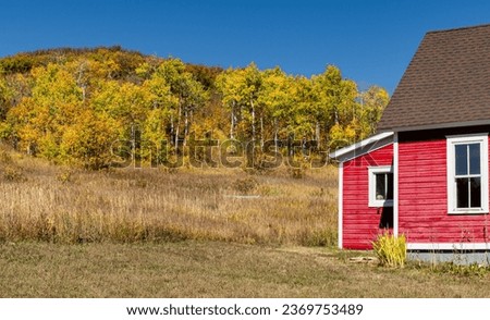 Little red schoolhouse in Hinton Gulch with fall foliage.