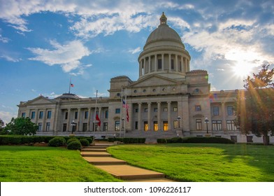 Little Rock, AR—May 20, 2018; sunset with clouds behind dome and columns of the Arkansas State capital building and grounds.