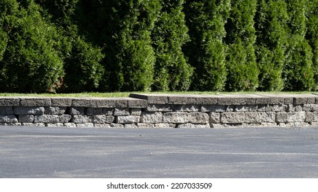 A Little Rock Wall In A Driveway