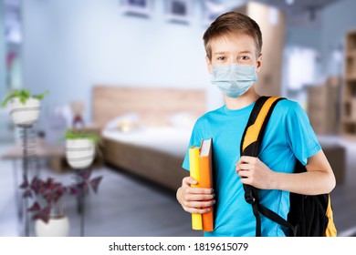 Little school boy holding books and looking at the camera - Shutterstock ID 1819615079