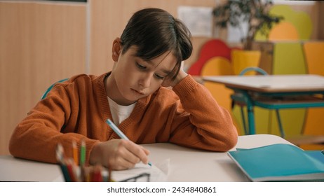 Little school boy primary schoolboy Caucasian son kid child clever smart writing task exercise at class lesson tired failure problem irritated trouble education difficulty hard studying learning study - Powered by Shutterstock