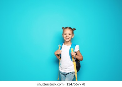 Little School Child With Backpack On Color Background