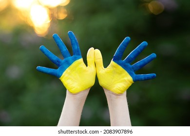 Little school girl showing hands painted in yellow and blue color. Kid hands painted in blue and yellow flag of Ukraine. Ukrainian Independence Flag Day. Constitution day. 24 August. Patriotic holiday - Shutterstock ID 2083907896