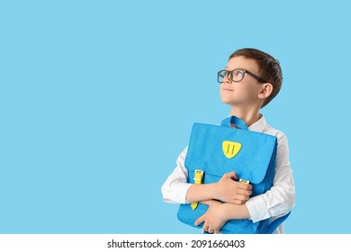 Little Schoolboy With Backpack On Color Background