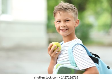 Little Schoolboy Eating Tasty Lunch Outdoors