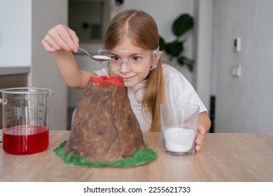 Little schoolgirl using soda to make chemical experiments at home. Little girl make easy scientific experimental at home, concept of learning from home, science for kid. - Powered by Shutterstock