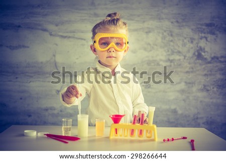 Similar – Image, Stock Photo Little scientist laughing behind of table with experiment elements