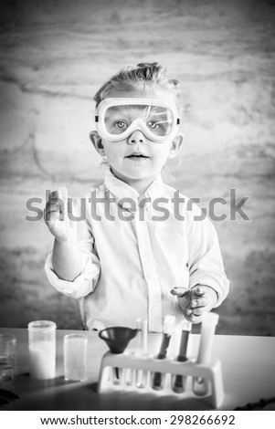 Similar – Image, Stock Photo Little scientist laughing behind of table with experiment elements