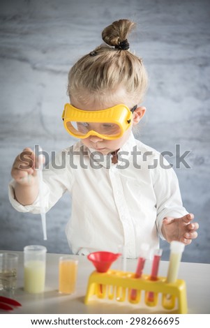 Similar – Kind macht Seifenblasen mit Strohhalm im Glas.