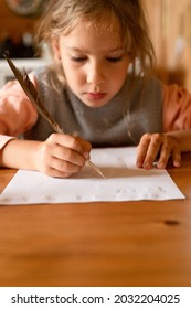 Little Seven Year Old Kid Girl Draws A Disappearing Drawing On A Paper With A Real Sharpened Duck Pen Using Milk Instead Of Ink