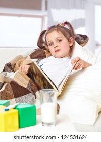 Little Sick Girl Reading A Book In Bed