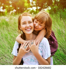 Little Sister Hugging Her Older Sister