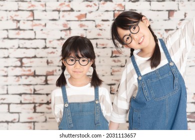 Little Sisters In Matching Clothes